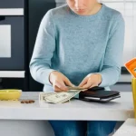 행태재정학과 소비자 심리 - **Theme: Money Disappearing and Mental Accounting**
    A person, appearing slightly bewildered, gaz...